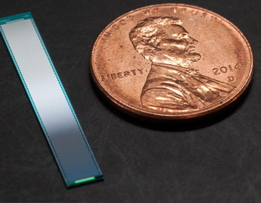 Image of MaxQ System ultrasound chip shown next to a penny for scale.