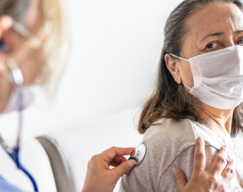 Physician checking patient's lungs